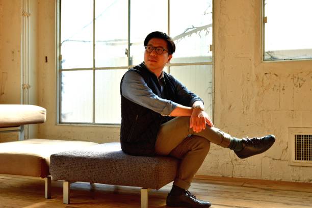 istock Chinese Man Relaxing in Corner of His Office during Lunch Break 1138404005