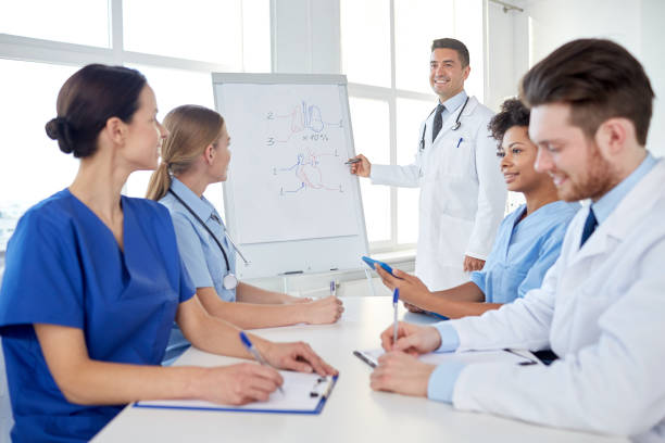 istock group of doctors on presentation at hospital 1138405594