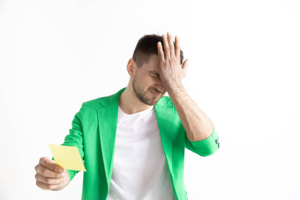 istock Young boy with a surprised unhappy failure expression bet slip on studio background. 1138406983