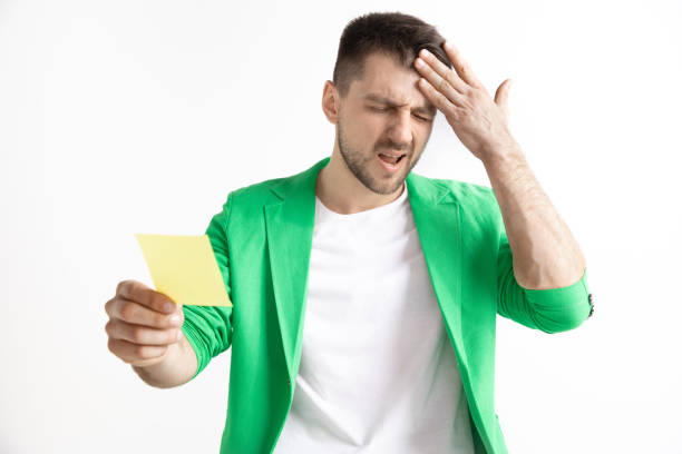 istock Young boy with a surprised unhappy failure expression bet slip on studio background. 1138406986