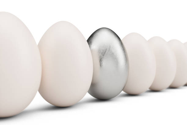 istock Silver egg around white eggs in row. Silver egg closeup. Silver egg as a sign of wealth, luxury. Egg as a symbol of easter, holiday, weekend, 3D illustration 1138407217