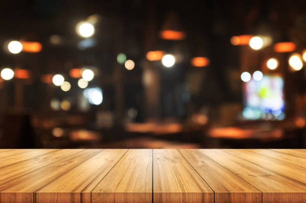 istock Empty wooden table top with blurred coffee shop or restaurant interior background. 1138411285