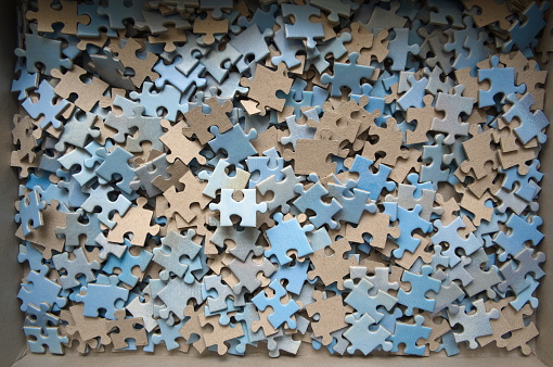 Puzzle pieces in the box mostly blue and white colors.