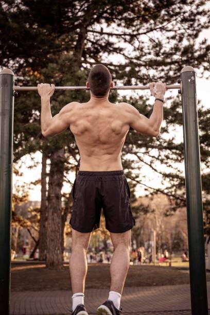 istock Handsome Young Athlete Doing Chin-ups on Horizontal Bar 1138411622