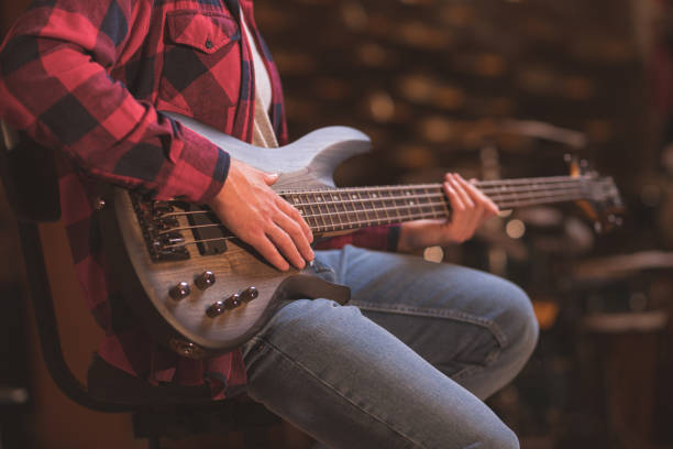 istock Young musician playing bass guitar 1138412231