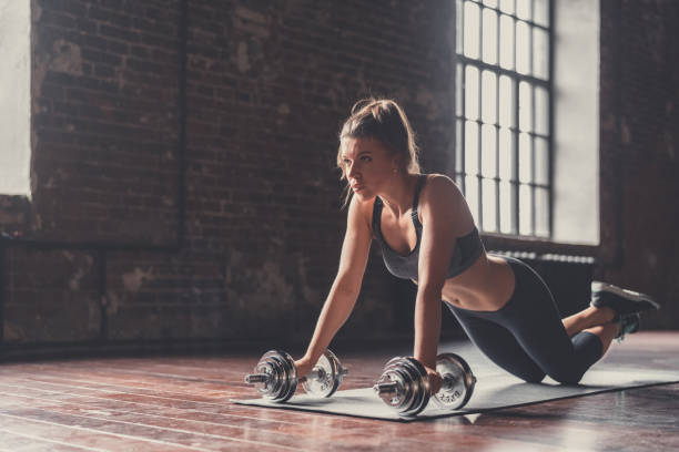 A young woman in the loft A young girl doing sports in the loft circuit training stock pictures, royalty-free photos & images