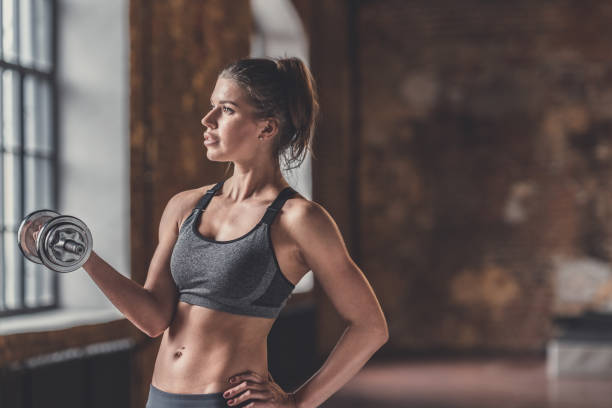 istock Young girl with a dumbbell 1138413191