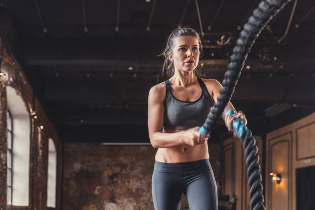 istock Young girl with a rope on a cross-training 1138413266