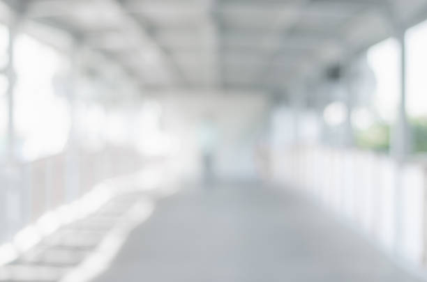 istock abstract blurred background outdoor walk way to shopping mall defocused depth white bokeh with customer walking in to hall of department store. 1138416414