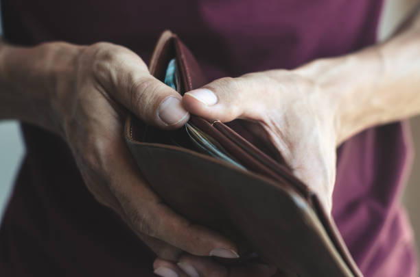 istock hipster man open show leather wallet with holding and take and pick money saving. wealth financial rich payment concept. 1138416785