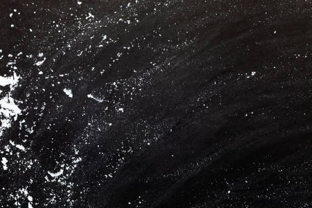 istock sprinkle wheat flour with copy space for text on dark black wood background, top view for cooking dough or pastry background 1138417855