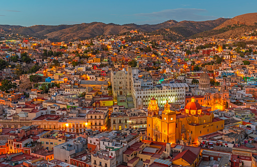 Cityscape of Guanajuato city during the blue hour with the famous orange Basilica of Our Lady of Guanajuato, Mexico.