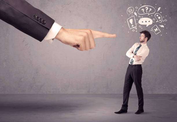 istock Boss hand pointing at confused employee 1138418264