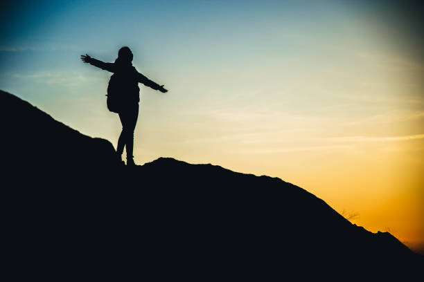 istock Woman hiking success silhouette 1138419271
