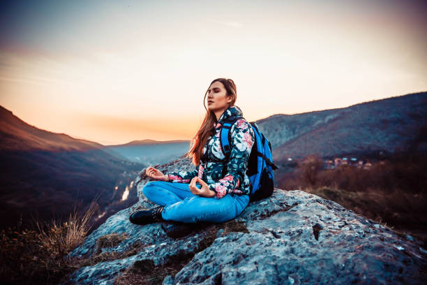 istock Meditating on top of mountain 1138419433