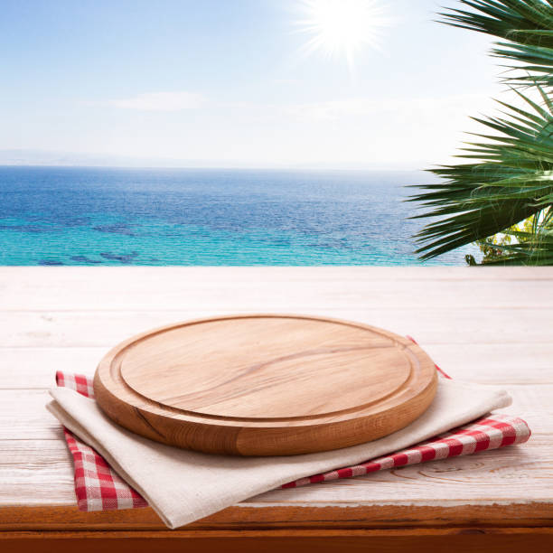 istock Pizza board, with tablecloth on wooden table and summer background. . Top view mockup 1138419670