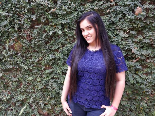 istock Beautiful young woman posing against wall 1138420102