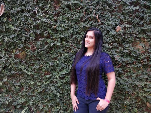 istock Beautiful young woman posing against wall 1138420166