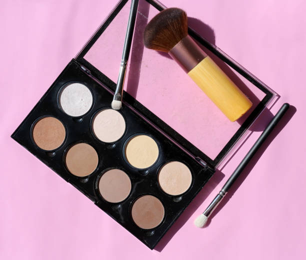 istock Makeup Palette for Highlight and Contour with Brushes on a Pink Surface 1138420279