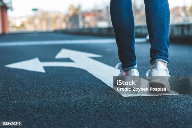 Make Decision Which Way To Go Walking On Directional Sign On Asphalt Road Stock Photo - Download Image Now