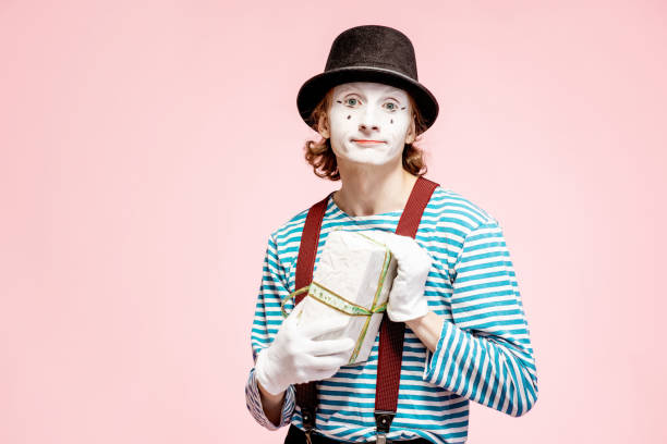 istock Pantomime with gift box on the pink background 1138421244
