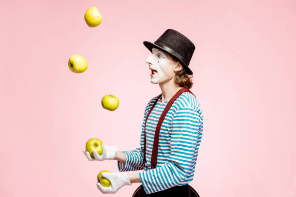 istock Pantomime juggling with apples on the pink background 1138421293