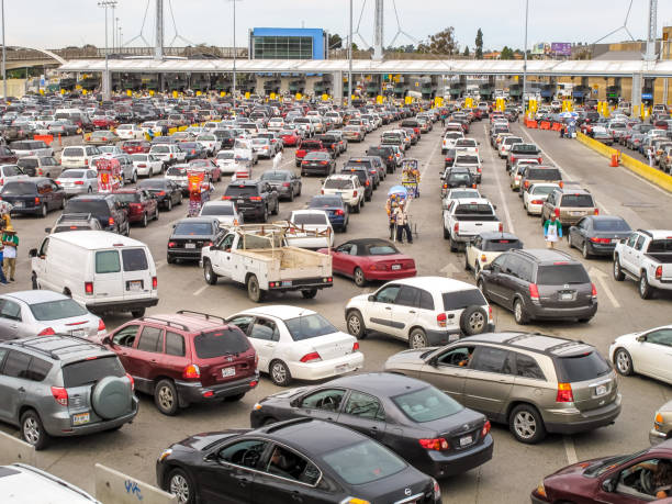 Hundreds of cars wait in line to cross the US-Mexico border at the San Ysidro Port of Entry in Tijuana in Mexico stock photo