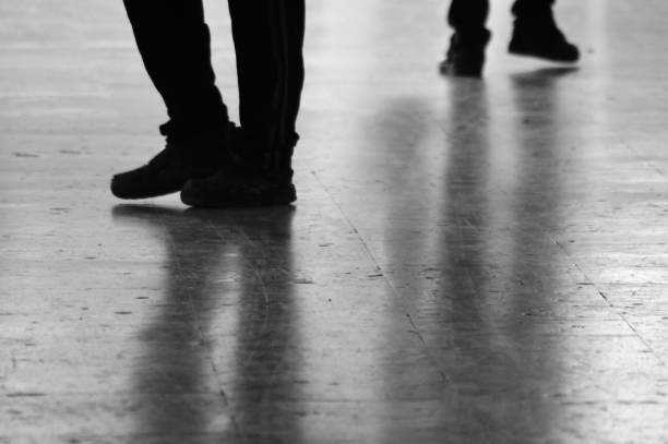 istock Black and white shot of moving legs on pavement 1138421794