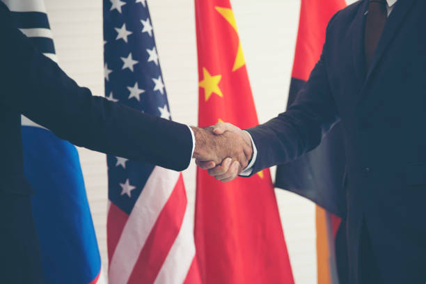 istock Businessmen holding hands With an international flag background 1138422346