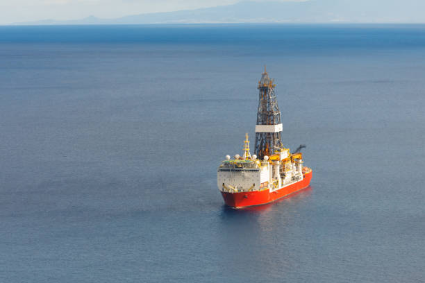 istock offshore oil and gas drillship, blue ocean background 1138423577