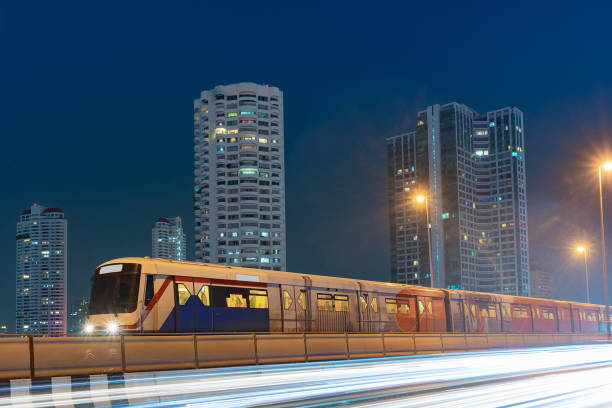 BTS sky train with long exposure light on Taksin Bridge, Bangkok, Thailand. cityscape background. BTS sky train with long exposure light on Taksin Bridge, Bangkok, Thailand. cityscape background. bts skytrain stock pictures, royalty-free photos & images