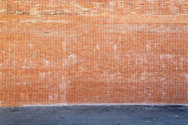 Photo of Huge brick wall and asphalt