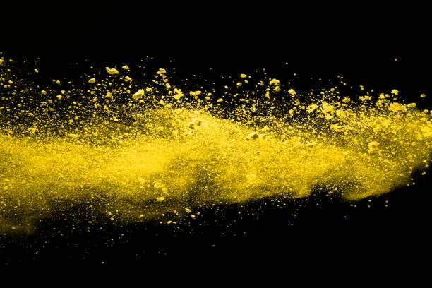 istock Freeze motion of yellow dust explosion isolated on black background. 1138425659