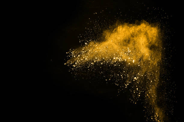 istock Freeze motion of yellow dust explosion isolated on black background. 1138425692