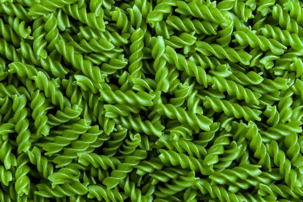 raw macaroni green background to use as a poster in markets or magazines