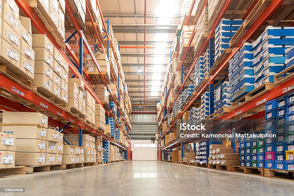 Rows of shelves. Rows of shelves with goods boxes in huge distribution warehouse at industrial storage factory. Warehouse Stock Photo