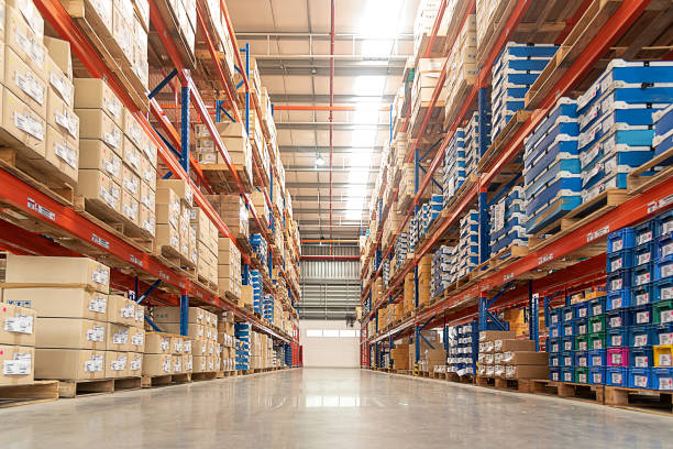 Rows of shelves. Rows of shelves with goods boxes in huge distribution warehouse at industrial storage factory. building story photos stock pictures, royalty-free photos & images