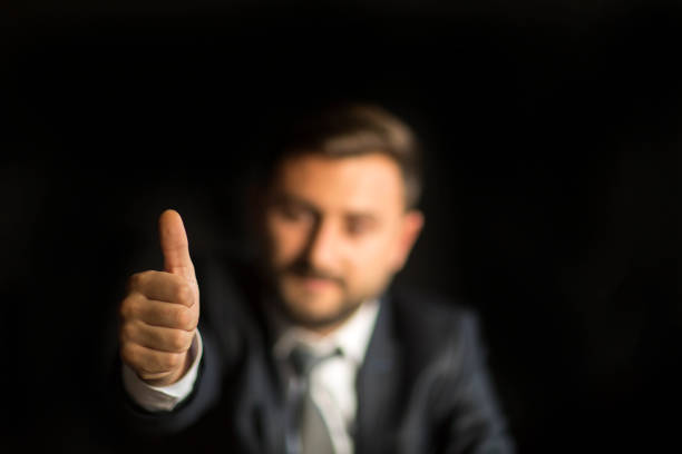 Business man shows thumb up sign gesture
