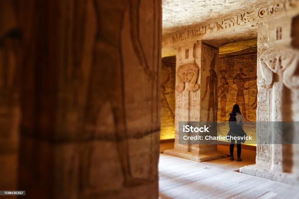 Abu Simbel - Traveller inside Nefertari Temple in Egypt Temple, Abu Simbel, Egypt, travel destination, ancient, ruins, hieroglyphs, epic, tourist, traveler Egypt Stock Photo