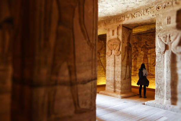 Abu Simbel - Traveller inside Nefertari Temple in Egypt Temple, Abu Simbel, Egypt, travel destination, ancient, ruins, hieroglyphs, epic, tourist, traveler horus photos stock pictures, royalty-free photos & images