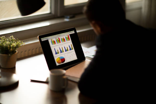 istock Young businessman showing graphs by pen 1138430428