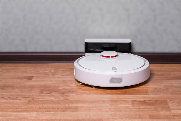 istock Robot vacuum cleaner on charging dock after it is finished. Modern smart electronic housekeeping technology 1138431622