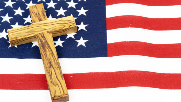 istock Wooden Cross on American Flag 1138435219
