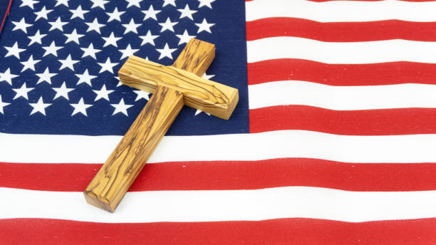 istock Wooden Cross on American Flag 1138435321