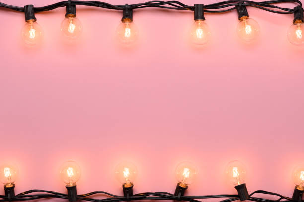 istock Retro garland Edison warm lights on pink pastel background. 1138435449