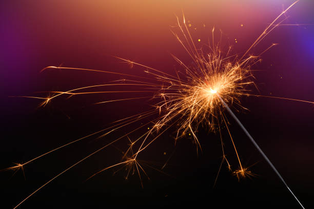 istock New year sparkler glittering candle magic festive light on dark background. 1138436891