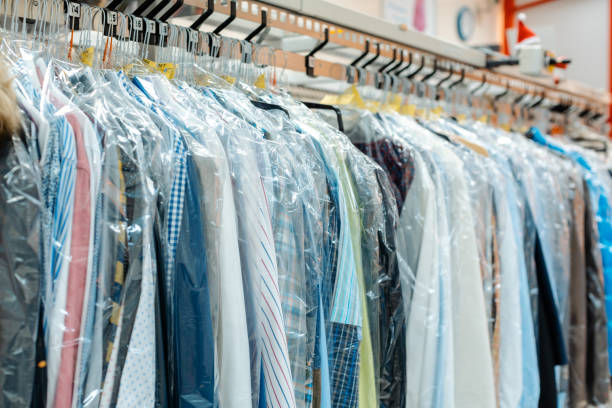 Carousel of clothing waiting for pick-up in dry cleaning shop stock photo