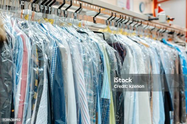 Carousel Of Clothing Waiting For Pickup In Dry Cleaning Shop Stock Photo - Download Image Now