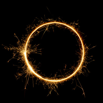 Sparkler circle shape. Burning Bengal fire round letter o number zero, long exposure. Burning sparklers isolated on black.