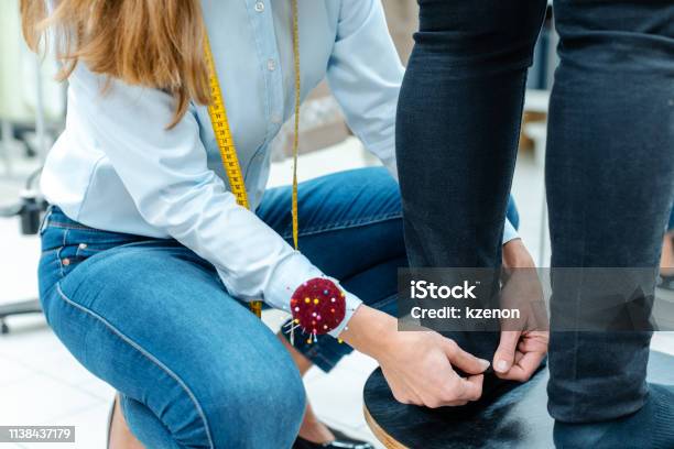 Alterations Tailor Measuring Trousers On A Customer Stock Photo - Download Image Now